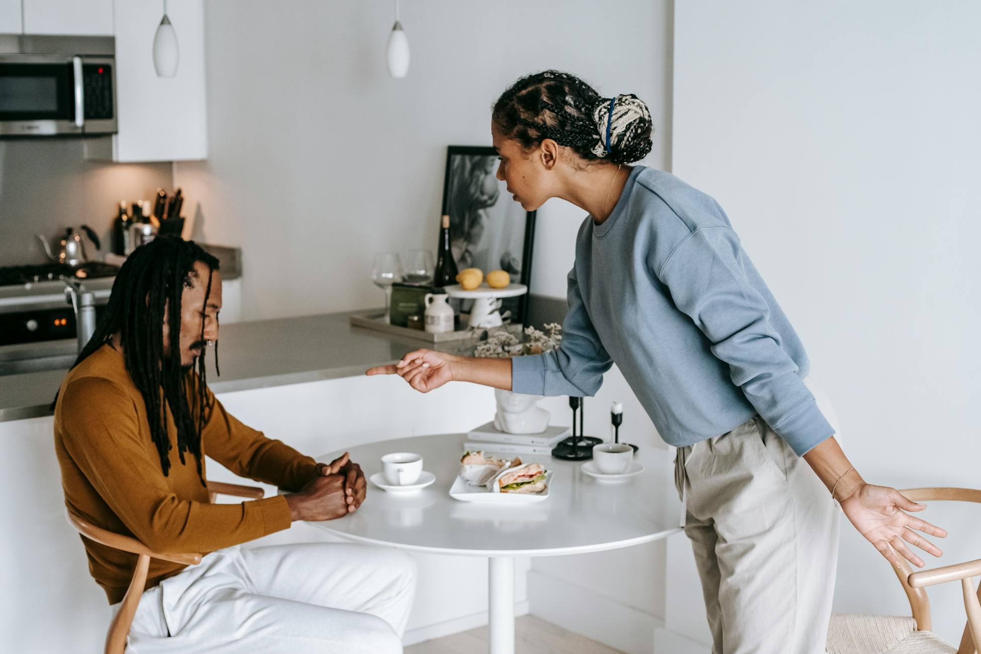 Young couple having an intense argument at home, reflecting relationship challenges and emotions.