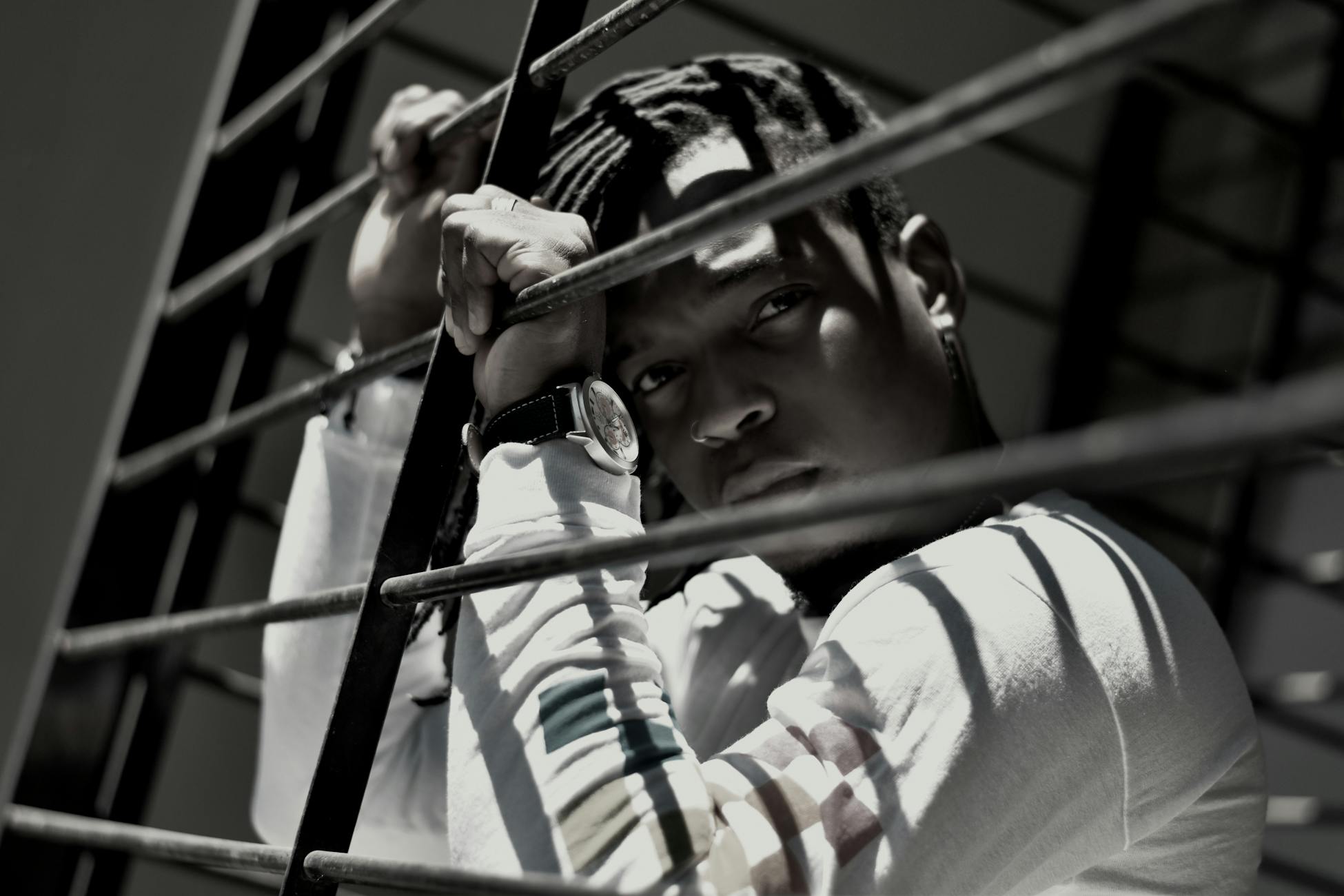 A contemplative portrait of a man through a window grill in Rosario.